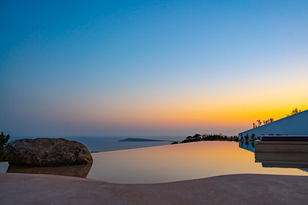 Sunset reflections across the infinity pool