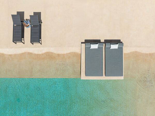 Aerial view of the pool edge and loungers