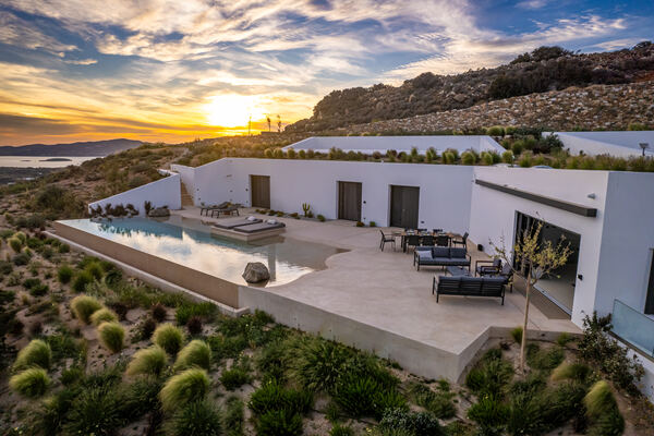 Aerial view of the villa and pool at sunset