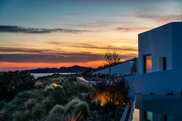 The villa exterior glowing at sunset