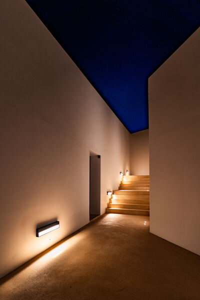 Lit stairway corridor at night
