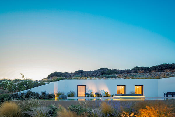The villa lit up at dusk