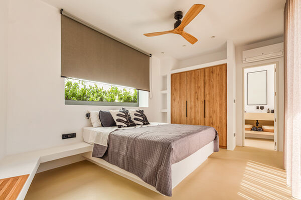 Bedroom with wood closet doors and ceiling fan