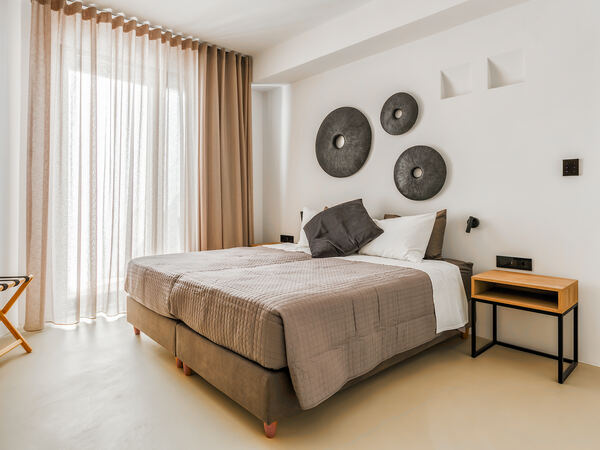 Bedroom with decorative wall art and sheer curtains