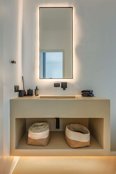 Bathroom vanity with mirror and woven baskets