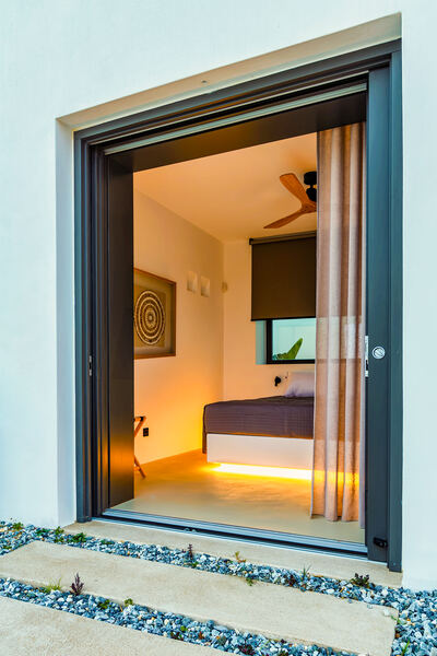 Bedroom opening onto the pool terrace, evening