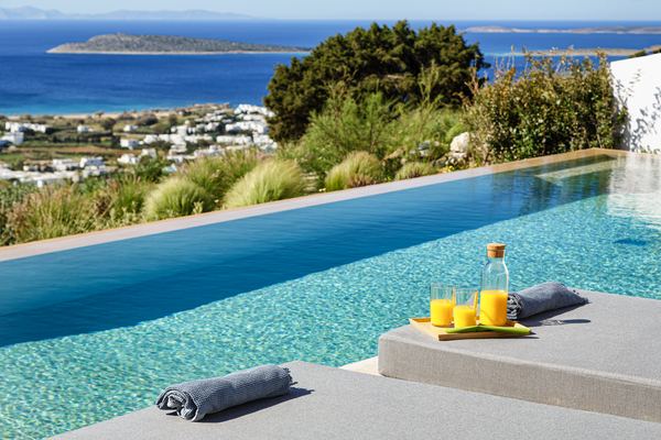 Infinity pool edge with breakfast service, morning light