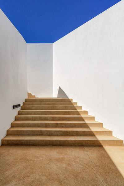 Exterior stairway beneath a blue sky corner