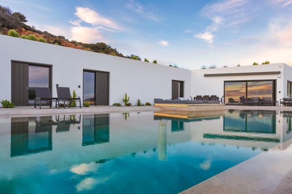 Villa and infinity pool at sunset