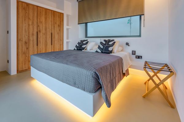 Bedroom with wood closet doors and backlit bed base