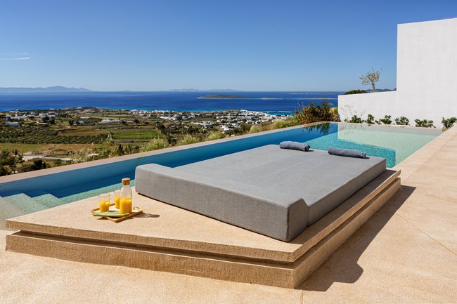 Poolside daybed with sea and hillside views