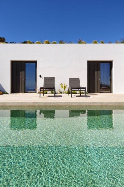 Bedroom terraces opening onto the shared pool deck