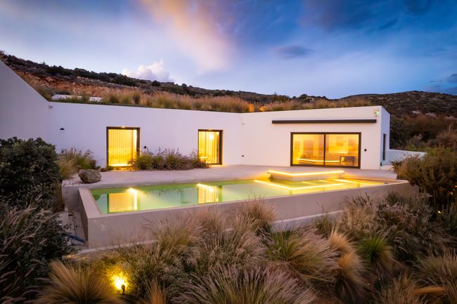 The villa and pool at dusk