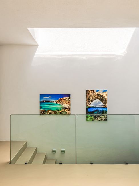 Stairwell to the lower level, lined with framed photography